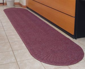 Waterhog Eco Grand Elite floor mat with Oval Two Ends placed in front of a service counter