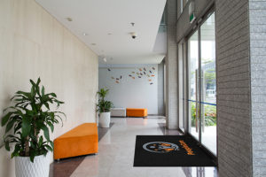 Business Entrance using Classic Impressions HD logo mat as an indoor door mat on top of granite floor
