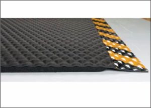 Close up side view of Hog Heaven anti fatigue matting with Yellow Striped border in a 5/8" thickness showing beveled edges and foam underside