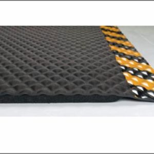 Close up side view of Hog Heaven anti fatigue matting with Yellow Striped border in a 5/8" thickness showing beveled edges and foam underside