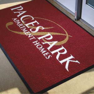 Waterhog Inlay custom floor mat with logo used inside an apartment building as an indoor logo mat