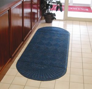 Waterhog Eco Grand Premier Oval Two Ends used as a floor mat runner in front of a hotel check in counter