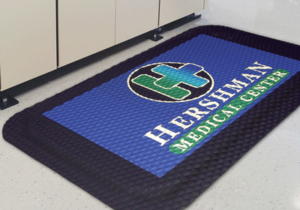 Close up view of a Hog Heaven Impressions Logo mat with logo embossed on a high quality anti fatigue matting in a hospital setting
