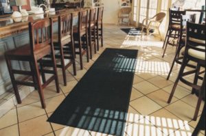 Olefin Indoor floor mat used as a runner on a hard floor in a restaurant