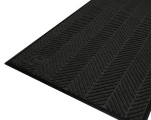 Corner view detailing surface pattern of a Waterhog Eco Elite entrance mat with standard edges in a Black smoke