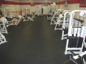 Heavy Duty Rubber Gym Floor matting with gym equipment placed on it in a school gym