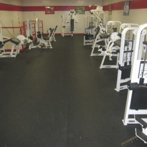 Rubber Rolled Gym Floor matting with gym equipment placed on it in a commercial gym