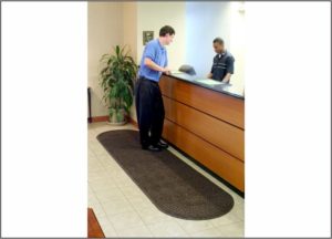 Waterhog Grand Classic Floor mat with Oval Fans on Two Ends in front of Hotel Check in counter