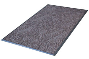 Waterhog Plus Swirl Floor Mat detailing the rubber edges and surface pattern of the entrance mat in a Grey Ash color